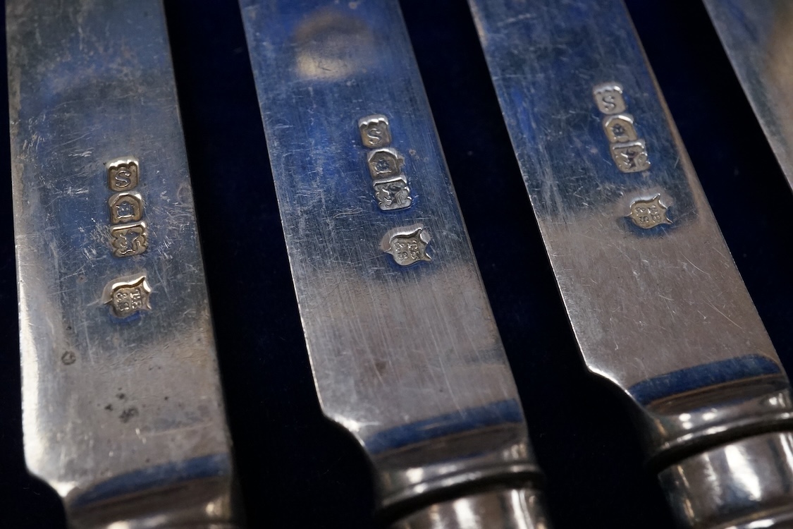 A set of twelve pairs of silver dessert eaters, by Thomas Bradbury & Sons, London, 1913, knife 19.8cm, handles loaded, housed in a fitted oak canteen.